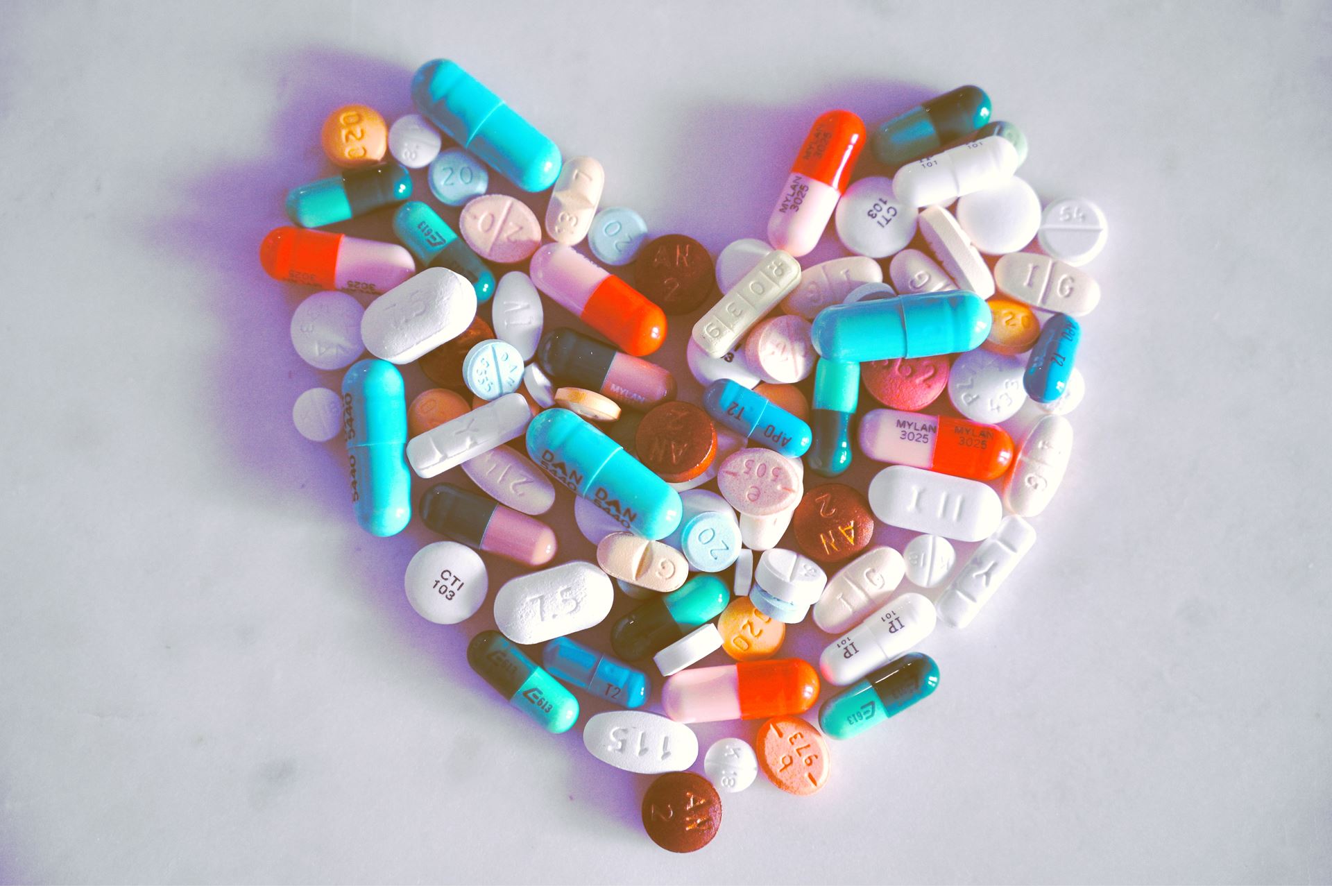 A selection of pills arranged in the shape of a heart