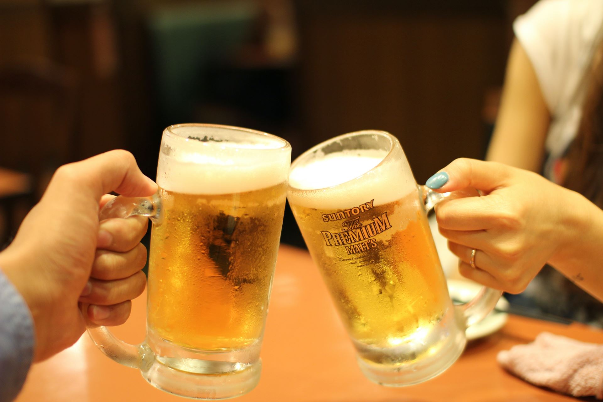 Two beer glasses being clinked together