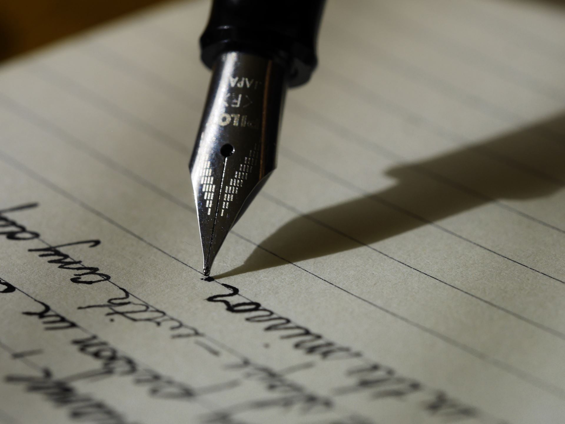 A fountain pen writing a letter