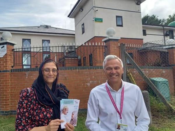 Parveen Khand Tim Wilkins standing in front of Crawley Mosque